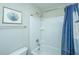 Bright bathroom with a white shower-tub combo and blue shower curtain at 616 W 2Nd N St, Summerville, SC 29483