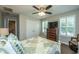 Bedroom featuring a ceiling fan, dresser with TV, and plantation shutters on the windows at 616 W 2Nd N St, Summerville, SC 29483