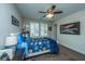 Bedroom with a ceiling fan, carpeted floor, and a bed with blue patterned sheets at 616 W 2Nd N St, Summerville, SC 29483