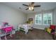 Cozy bedroom featuring plush carpet, bright windows, and ceiling fan at 616 W 2Nd N St, Summerville, SC 29483