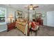 Charming bedroom featuring a four-poster bed, ceiling fan, and wood furniture at 616 W 2Nd N St, Summerville, SC 29483
