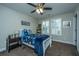 Bedroom with a ceiling fan, carpeted floor, and a bed with blue patterned sheets at 616 W 2Nd N St, Summerville, SC 29483