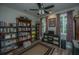 Bedroom featuring wood floors, a ceiling fan, and three shelving units filled with books at 616 W 2Nd N St, Summerville, SC 29483