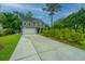 Two-story home with a long driveway, attached garage, and manicured landscaping at 616 W 2Nd N St, Summerville, SC 29483