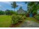 Home exterior with manicured shrubs along driveway and backyard with stained fence at 616 W 2Nd N St, Summerville, SC 29483