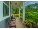 Comfortable front porch area with seating, potted plants, and views of the landscaped yard at 616 W 2Nd N St, Summerville, SC 29483