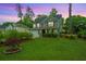 Charming two-story home featuring a well-manicured lawn, landscaping, and inviting curb appeal at 616 W 2Nd N St, Summerville, SC 29483
