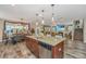 View of kitchen granite counters, stainless appliances, dark wood cabinetry, breakfast bar, and access to living spaces at 616 W 2Nd N St, Summerville, SC 29483