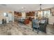 Open layout showcasing kitchen with granite island, seating, stainless appliances, and adjacent dining space at 616 W 2Nd N St, Summerville, SC 29483