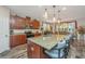Open kitchen with granite countertops, stainless steel appliances, island with seating and pendant lighting at 616 W 2Nd N St, Summerville, SC 29483
