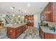 Well-equipped kitchen with granite countertops, island, stainless steel appliances, and wood-look floors at 616 W 2Nd N St, Summerville, SC 29483