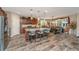 Spacious open kitchen with granite counters, island with barstool seating, stainless appliances, and wood-look floors at 616 W 2Nd N St, Summerville, SC 29483