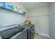 Practical laundry room with modern washer/dryer and storage shelving at 616 W 2Nd N St, Summerville, SC 29483