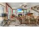 Cozy living room showcasing a fireplace, TV, hardwood floors, ceiling fan, and stairway at 616 W 2Nd N St, Summerville, SC 29483