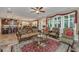 Spacious living room featuring hardwood floors, decorative rug, fireplace, ceiling fan, and natural light at 616 W 2Nd N St, Summerville, SC 29483