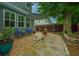 Private patio and stone pathway with an umbrella and seating near a large shade tree at 616 W 2Nd N St, Summerville, SC 29483