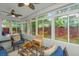 Bright sunroom with slate floors and surrounded by large windows, with ceiling fans at 616 W 2Nd N St, Summerville, SC 29483