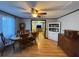 Cozy dining room featuring wood floors, a ceiling fan, and an open view to the living room at 6760 Yemassee Hwy, Varnville, SC 29944