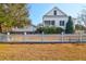 Charming house with a well-maintained yard, white picket fence, and lush trees at 6902 Tanner Hall Blvd, Hanahan, SC 29410