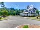 Exterior of the white community barn with asphalt parking at 6902 Tanner Hall Blvd, Hanahan, SC 29410