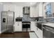 Stylish kitchen with stainless steel appliances, white cabinets, and attractive backsplash tiles at 705 Melrose Dr, Charleston, SC 29414