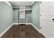 Spacious walk-in closet with built-in shelves and dark wood flooring at 705 Melrose Dr, Charleston, SC 29414