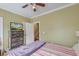 Cozy bedroom featuring a ceiling fan, dresser with a TV, and doorway leading to the next level at 949 E Estates Blvd # 303, Charleston, SC 29414