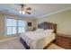 Cozy bedroom with a large bed, wooden furniture, and a window with blinds at 949 E Estates Blvd # 303, Charleston, SC 29414