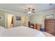 Comfortable bedroom featuring a bed, dresser, ceiling fan, and closet access at 949 E Estates Blvd # 303, Charleston, SC 29414