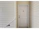 White front door of a home with tan siding and a pink heart decoration on the door at 949 E Estates Blvd # 303, Charleston, SC 29414