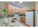 Bright kitchen with wooden cabinets, white appliances, and plenty of counter space for cooking at 949 E Estates Blvd # 303, Charleston, SC 29414