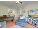 Open-concept living room features a lounge chair, wooden table, and TV stand with decorations at 949 E Estates Blvd # 303, Charleston, SC 29414
