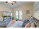 Comfortable living room with a gray sofa, various potted plants, and a patio door at 949 E Estates Blvd # 303, Charleston, SC 29414