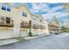 View of a row of townhomes each with a garage and outdoor patio at 949 E Estates Blvd # 303, Charleston, SC 29414