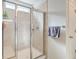 Bathroom featuring a tiled walk-in shower with glass doors and a shower bench at 9830 Black Tupelo Ln, Ladson, SC 29456