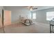 Bright bedroom with neutral carpet, a ceiling fan, and large windows providing natural light at 9830 Black Tupelo Ln, Ladson, SC 29456