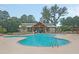 Community pool with lounge chairs and a covered seating area surrounded by lush greenery at 9830 Black Tupelo Ln, Ladson, SC 29456