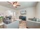 Cozy living room with stylish furniture, a ceiling fan, and ample natural light at 9830 Black Tupelo Ln, Ladson, SC 29456