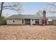 Back exterior with patio and mature trees at 112 Chownings Ln, Goose Creek, SC 29445