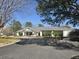 A charming one-story clubhouse with a welcoming entrance and well-maintained landscaping at 112 Chownings Ln, Goose Creek, SC 29445