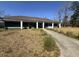 Exterior view of amenity center with walkway, lawn, and manicured landscaping at 112 Chownings Ln, Goose Creek, SC 29445