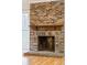 Close-up of brick fireplace with wood mantle and hearth at 112 Chownings Ln, Goose Creek, SC 29445