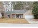 Inviting single-story home with a charming front porch and attached garage in a quiet, wooded neighborhood at 112 Chownings Ln, Goose Creek, SC 29445