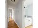 Hallway with wood flooring and an adjacent partial bath at 112 Chownings Ln, Goose Creek, SC 29445