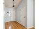 Clean hallway featuring hardwood floors and neutral walls, providing a seamless flow to other rooms in the house at 112 Chownings Ln, Goose Creek, SC 29445