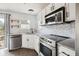 Updated kitchen features stainless steel appliances, white cabinets, granite countertops, and a marble tile backsplash at 112 Chownings Ln, Goose Creek, SC 29445