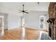 Spacious living room featuring a vaulted ceiling, ceiling fan, fireplace, and wood-look flooring at 112 Chownings Ln, Goose Creek, SC 29445