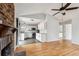 Open living room, kitchen and dining area concept with fireplace, ceiling fan, and wood-look flooring at 112 Chownings Ln, Goose Creek, SC 29445