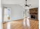 Spacious living room featuring a vaulted ceiling, ceiling fan, fireplace, wood-look flooring, and large windows at 112 Chownings Ln, Goose Creek, SC 29445