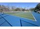Outdoor tennis court with blue surface and green in-bounds; tall net and chain-link fence at 112 Chownings Ln, Goose Creek, SC 29445